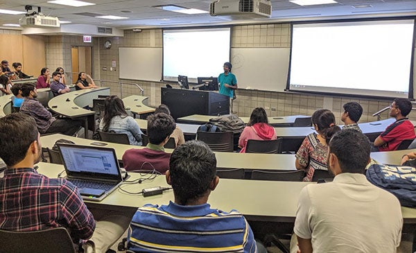 INFORMS members sitting in a classroom at an event