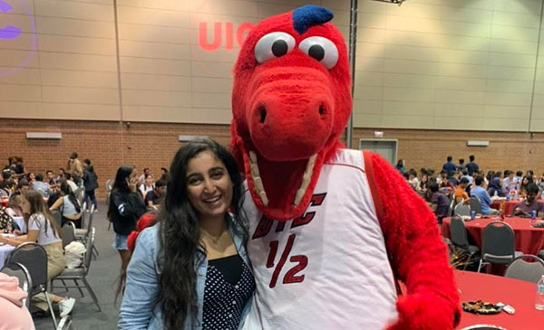 Nikhita Wadhawan with the UIC mascot, Sparky D. Dragon