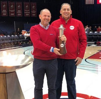 Brad Sargent ’99 and Dean Michael Mikhail with the UIC torch 