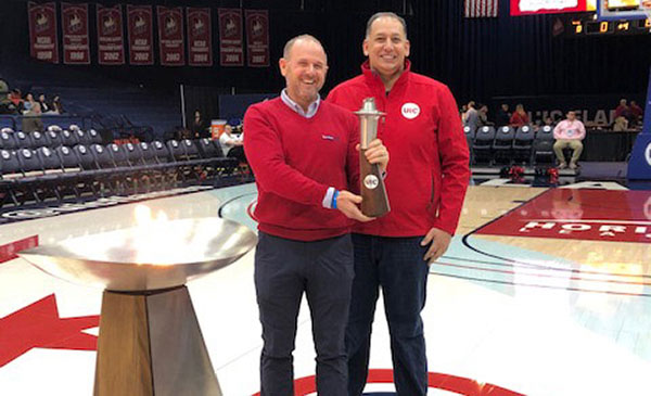 Brad Sargent ’99 and Dean Michael Mikhail with the UIC torch