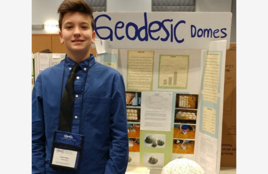 Quinn participating in the regional science fair during his freshman year of high school, where he studied geodesic domes.