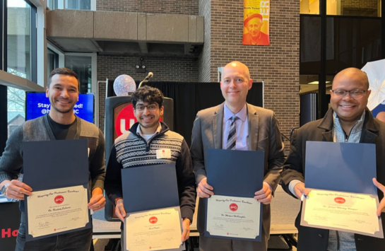 UIC Business faculty members with the HOPE Award. From left to right: Rustam Zufarov, Neel Patel, Michael McLaughlin, and James Wesley Cooper